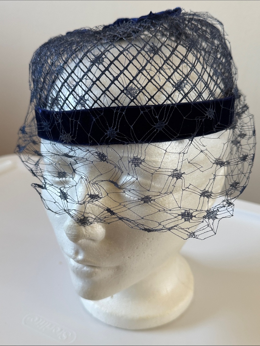 Vintage navy blue pillbox veiled hat with velvet bow, classic